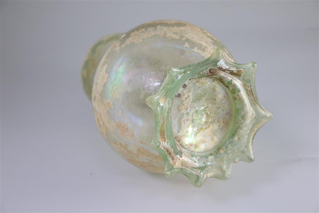 A good Roman olive green glass ewer or pitcher, Eastern Mediterranean, 3rd/4th century AD, 32cm high